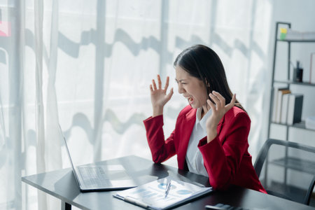 Portrait of business owner, woman using computer and financial statements Anxious expression on expanding the market to increase the ability to invest in business.の写真素材