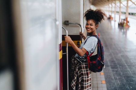 Tourists african american are showing happy expressions while waiting for their journey in the train stationの写真素材