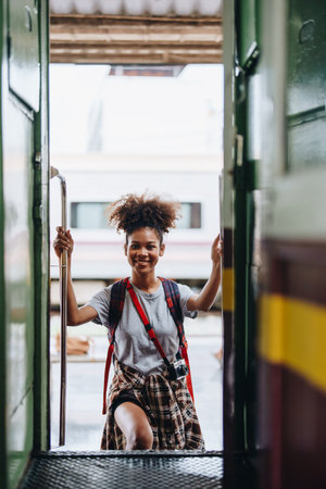 Tourists african american are showing happy expressions while waiting for their journey in the train stationの写真素材