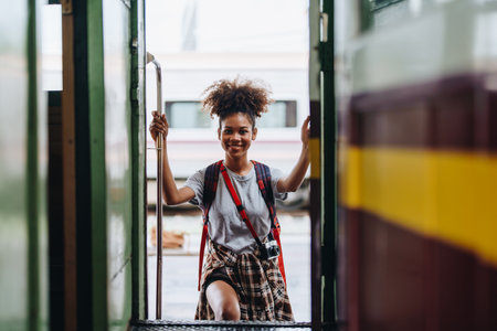Tourists african american are showing happy expressions while waiting for their journey in the train stationの写真素材