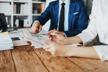 Asian business advisor meeting to analyze and discuss the situation on the financial report in the meeting room.Investment Consultant, Financial , teamwork ,brainstorming ,startup and accounting.の写真素材