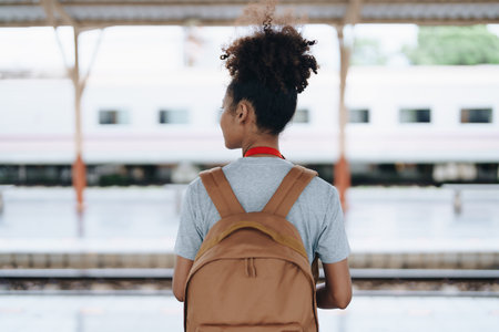 Tourists african american are showing happy expressions while waiting for their journey in the train stationの写真素材