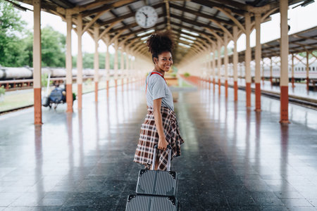 Tourists african american are showing happy expressions while waiting for their journey in the train stationの写真素材