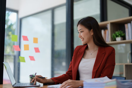 planning, auditing, business planning, finance, young asian business woman working on computer and checking investment documents and planning marketing to increase profit, business conceptsの写真素材