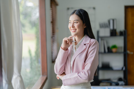 Excited businesswoman using computer laptop while in office, business conceptsの写真素材