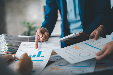 Asian business advisor meeting to analyze and discuss the situation on the financial report in the meeting room.Investment Consultant, Financial , teamwork ,brainstorming ,startup and accounting.の写真素材