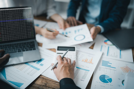 Asian business advisor meeting to analyze and discuss the situation on the financial report in the meeting room.Investment Consultant, Financial , teamwork ,brainstorming ,startup and accounting.の写真素材