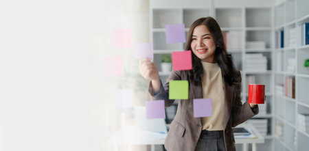 Beautiful young teen asian businesswoman using note pad thinking with planning working on financial document, tax, exchange, accounting and Financial advisor.の写真素材