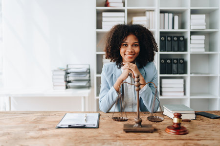 A young women African American lawyer lawsuit studying cases for clients in a law firm to fight against their parties in the courts. law and attorney conceptsの写真素材