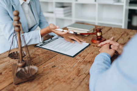 african american attorney, lawyers discussing contract or business agreement at law firm office, Business people making deal document legal, justice advice service concepts.の写真素材