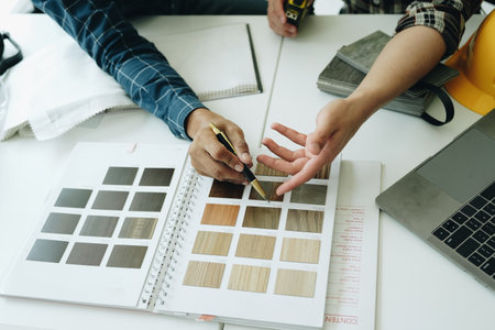 Engineers, designers and interior designers are finalizing the design of interiors by discussing selecting materials and colors to design rooms to present to clientsの写真素材