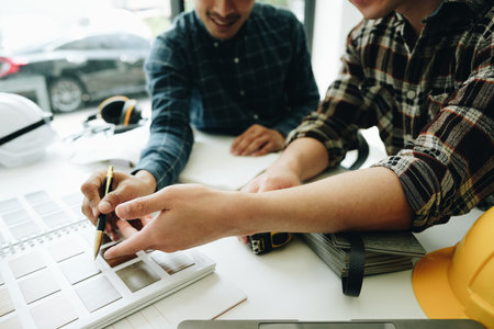 Engineers, designers and interior designers are finalizing the design of interiors by discussing selecting materials and colors to design rooms to present to clientsの写真素材