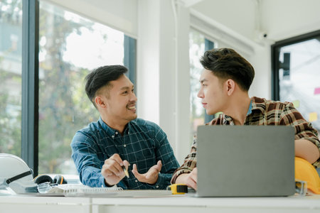 Engineers, designers and interior designers are finalizing the design of interiors by discussing selecting materials and colors to design rooms to present to clientsの写真素材