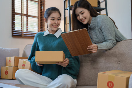 Starting small business entrepreneur of independent young Asian woman online seller is using...