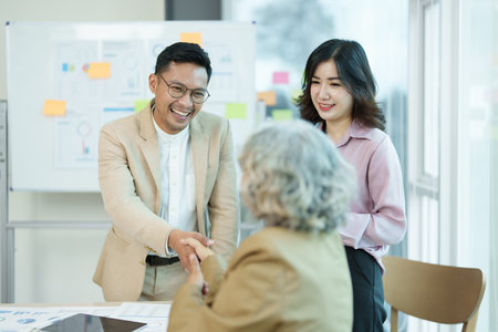 Asian entrepreneurs handshakes to congratulate the agreement between the two companies to enhance investment and financial strength. deal concept.の写真素材