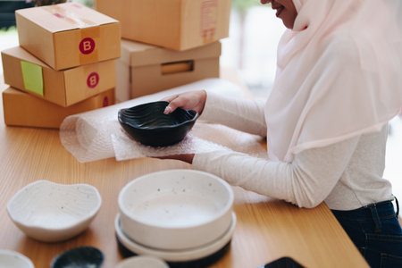 Beautiful Muslim woman selling online at home, business owner, business sme concepts.の写真素材