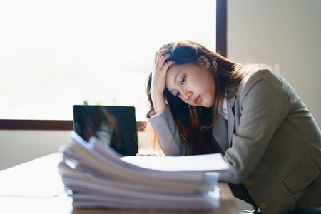 Portrait of sme business owner, man using computer and financial statements Anxious expression on...