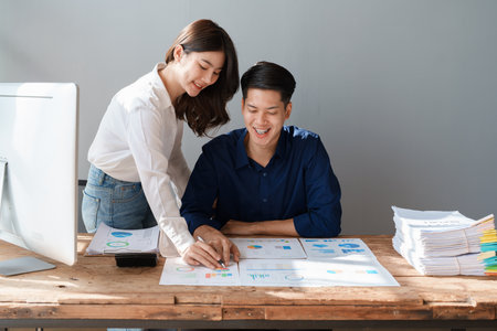 Startup family business, husband and wife discussing financial affairs, investing, making profit, tax deduction from trading using computer and investment budget paperwork working.の写真素材