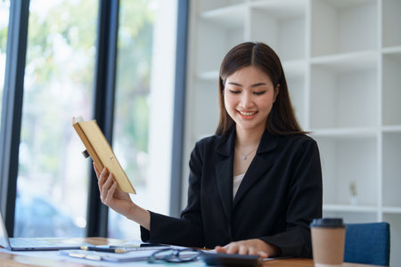 Business planning, portrait of a business woman using a computer to audit financial statements and marketing.の写真素材