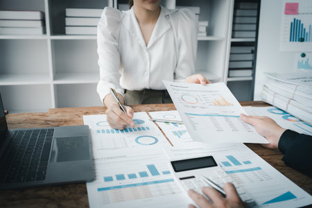 startup Asian business advisor meeting to analyze and discuss the situation on the financial report in the meeting room.の写真素材