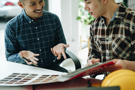 Engineers, designers and interior designers are finalizing the design of interiors by discussing selecting materials and colors to design rooms to present to clientsの写真素材
