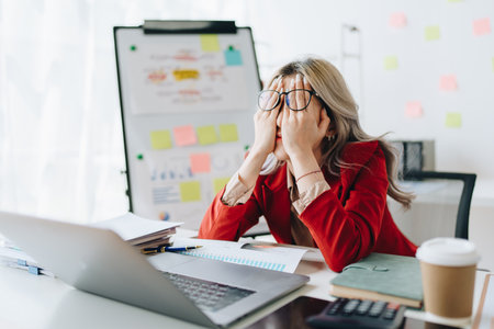 Portrait of business owner, woman using computer and financial statements Anxious expression on...