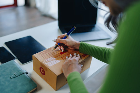 Starting small business entrepreneur of independent Asian female online seller packing products to send to customers and SME delivery concept.の写真素材