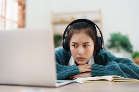 Studying online, beautiful Asian female student show symptoms burnout syndrome student studying...