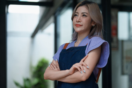 Starting small business entrepreneur of independent Asian woman smiling using computer laptop with cheerful success of online marketing package box items and SME delivery concept.の写真素材