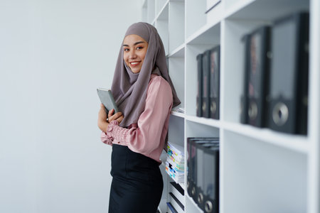 Muslim female employee Searching for documents in the officeの写真素材