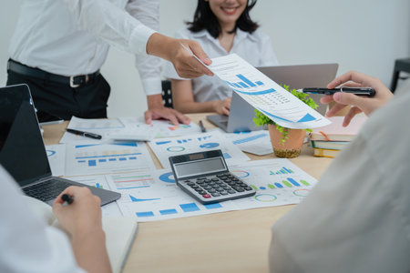 Asian business advisor meeting to analyze and discuss the situation on the financial report in the...