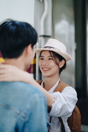 Tourist couples showing their love and happiness in a sweet way while waiting for their journey at the train stationの写真素材