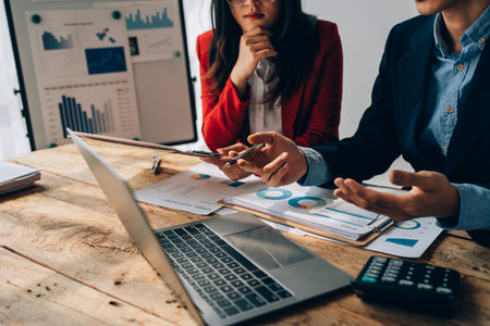 startup business, business advisor explaining strategy for planning finance investment teamwork paperwork audit and discussing marketing, profit, budget of company in meeting roomの写真素材