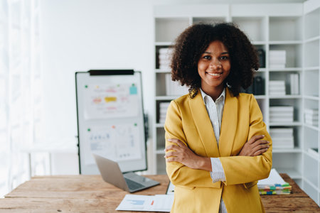 American African business woman using document, computer laptop, calculator, paperwork, documents, in winner and smiling Happy to be successful achievement success. finance and investment concepts.の写真素材
