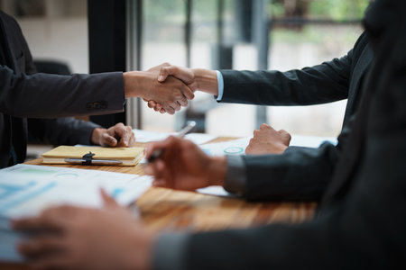 multi ethnic engineer brainstorming with deal and measuring for cost estimating on paperworks and floor plan drawings, contract and agreement concepts.の写真素材