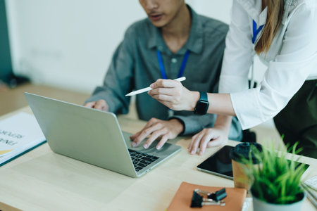 startup business, business advisor explaining strategy for planning finance investment teamwork paperwork audit and discussing marketing, profit, budget of company in meeting roomの写真素材