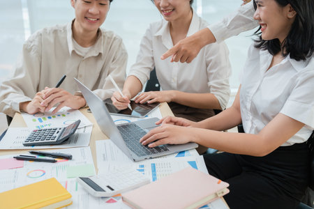 startup Asian business advisor meeting to analyze and discuss the situation on the financial report in the meeting room.の写真素材