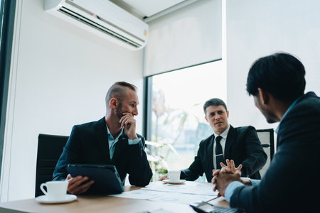 Asian business advisor meeting to analyze and discuss the situation on the financial report in the meeting room.Investment Consultant, Financial , teamwork ,brainstorming ,startup and accounting.の写真素材