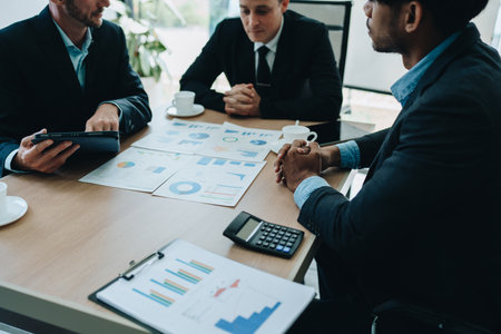 Asian business advisor meeting to analyze and discuss the situation on the financial report in the meeting room.Investment Consultant, Financial , teamwork ,brainstorming ,startup and accounting.の写真素材