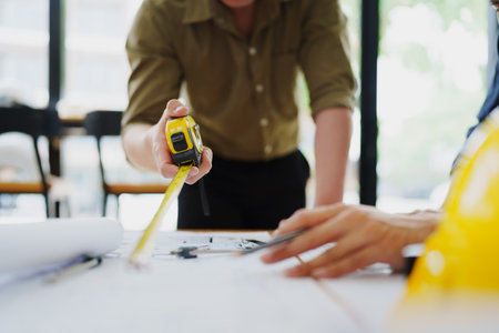 engineers discuss building on blueprint drawing, design building Project in officeの写真素材