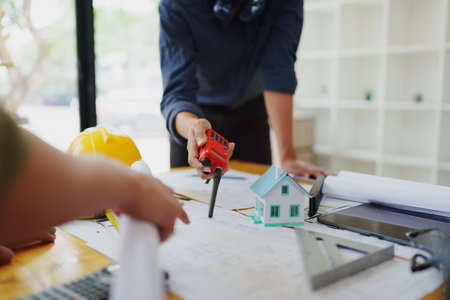 engineers discuss building on blueprint drawing, design building Project in officeの写真素材