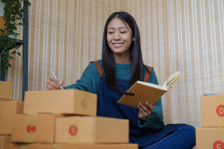 Asian female business owner handles delivery of orders to customers.