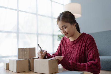 woman, online seller, efficiently manages customer orders and delivery through the e-commerce...