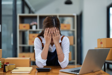 Young woman engaged in online business with stress thoughtful within data products Sales did not meet target Selling products of This month.の写真素材