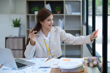 professional businesswoman with planning takes a notepad financial documents and marketing charts at work.の写真素材
