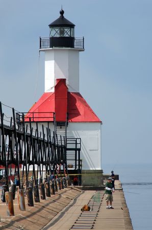 Fishermen fishing by St. Joseph Lighthouse, Michigan.の写真素材
