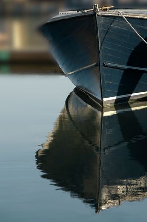 Blue boat bow reflections in the water.の写真素材