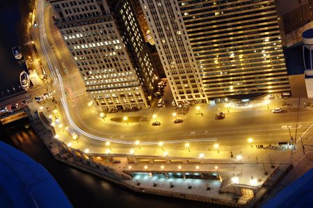 View of the lights of downtown Chicago from the top of Marina Towers at night. Wacker Drive and the...