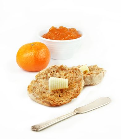 English muffin with orange and marmalade on white background.の写真素材