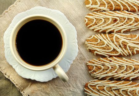 Cup of coffee with oatmeal cranberry cookies on woven cloth napkins.の写真素材